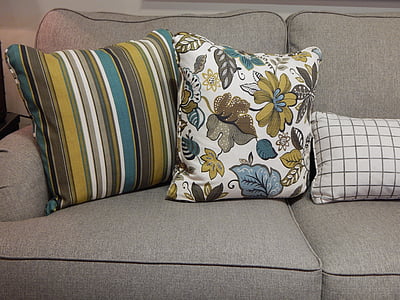 three gray and green throw pillows on sofa thumbnail
