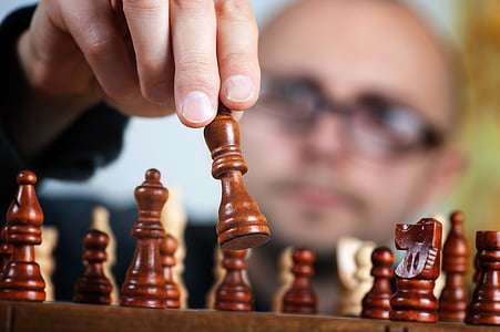 person playing chess board game thumbnail