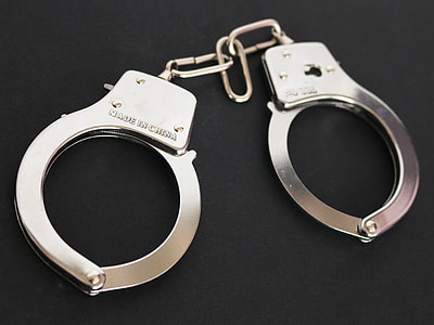silver handcuffs on black surface thumbnail