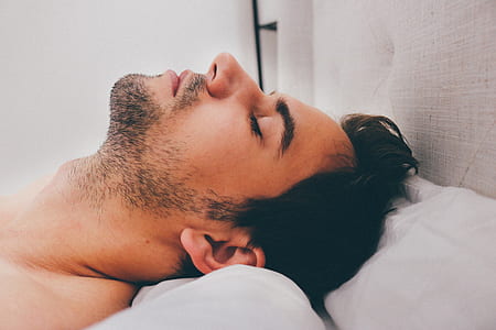 man sleeping on white bed thumbnail