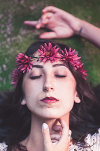 shallow focus photo of woman closing her eyes with pink flower crown thumbnail