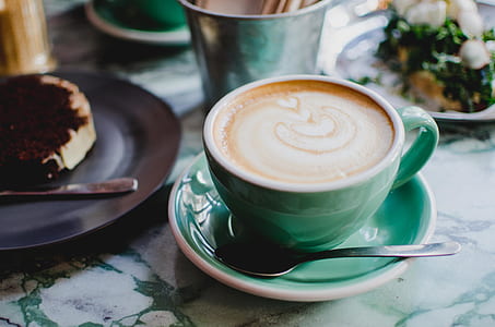 coffee late on blue ceramic cup and sliced chocolate cake on black plate thumbnail