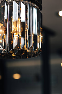 Elegant black designer chandelier with a lit lightbulb thumbnail