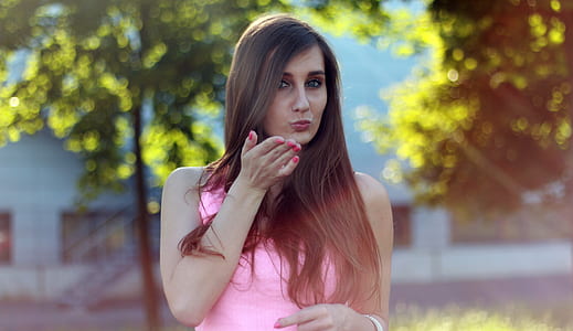 selective focus photo of woman wearing pink tank top thumbnail