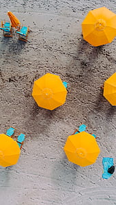 orange patio umbrella near seashore thumbnail