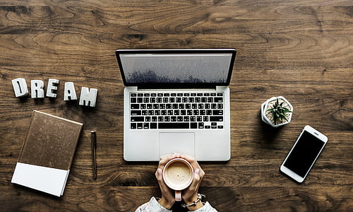 silver MacBook beside white smartphone thumbnail