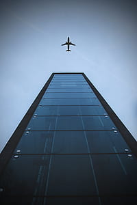airplane flying over buiding thumbnail