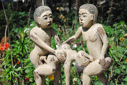 woman and man statue near flower thumbnail