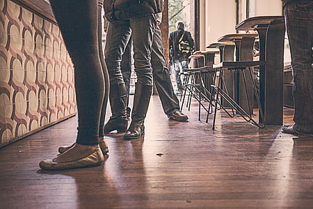 photo of three people standing on brown parquet floor room thumbnail