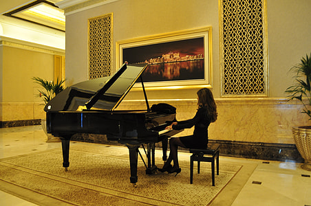 woman in black dress playing piano on room thumbnail