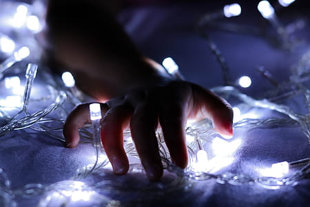 person touching white string light thumbnail