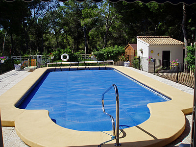 above land swimming pool enclosed by black metal gate thumbnail