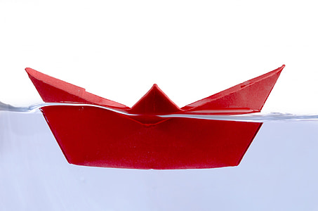 black paper boat in clear water thumbnail