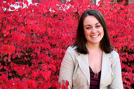 woman surrounded by pink leafed tree thumbnail
