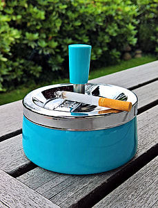 red single cigarette on gray and blue ashtray thumbnail