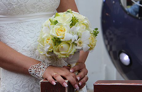woman wearing white gown holding flower bouquet thumbnail
