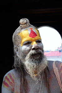 man with yellow and red painted face portrait photo thumbnail