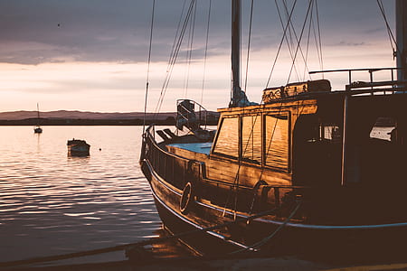 Photo of Ship on Water during Sunset thumbnail