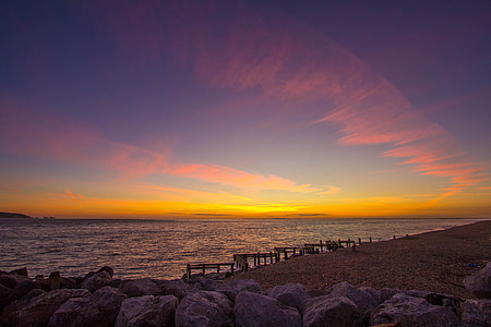 rocks near sea during golden hour thumbnail