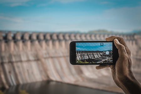 person taking a photo of dam thumbnail