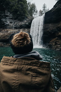 man standing in front of waterfalls thumbnail