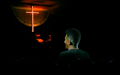 man facing in front of cross thumbnail