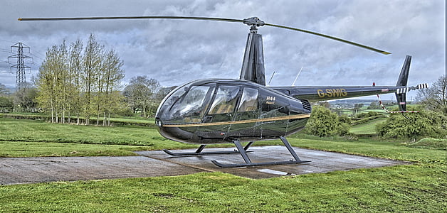gray helicopter on land thumbnail