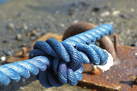 braided blue rope ties on brown metal bracket thumbnail