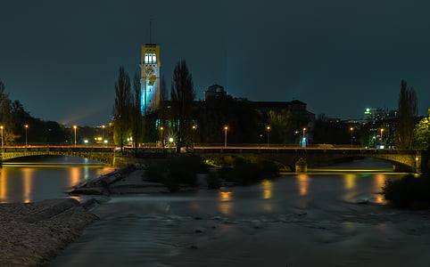 grey concrete tower near trees at night thumbnail