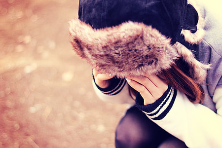 woman wearing brown and black trapper hat thumbnail