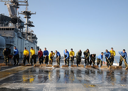 people cleaning flight deck of an aircraft carrier thumbnail