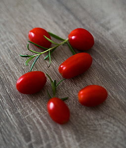 six red tomatoes on wooden surface thumbnail