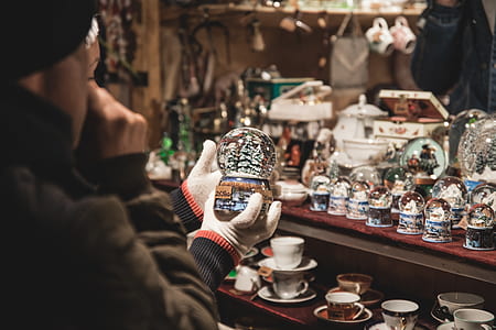 person holding snow globe thumbnail