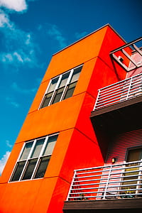 Low-angle Photography of Orange Concrete Building Under Blue and White Sky thumbnail
