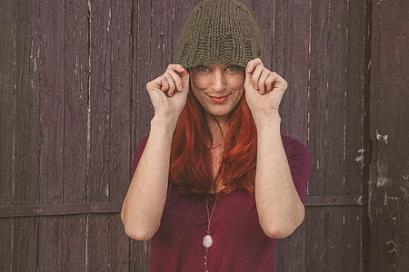 Woman Wearing Maroon Scoop-neck Shirt With Brown Knit Cap thumbnail
