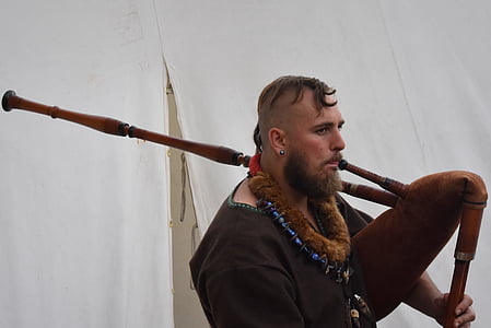 man holding brown weapon thumbnail