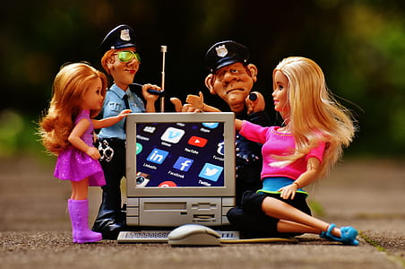 four dolls near computer toy thumbnail