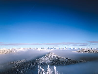 aerial photography of mountain covered with snow under blue sky during daytime thumbnail