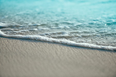 closeup photography of ocean foam on shore thumbnail