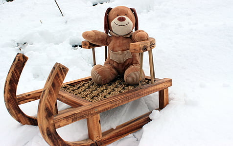 brown dog plush toy on brown sled thumbnail