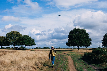 person walking beside grass thumbnail