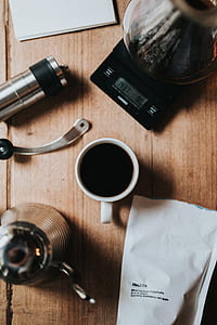 cup of coffee beside coffeemaker and white paper thumbnail