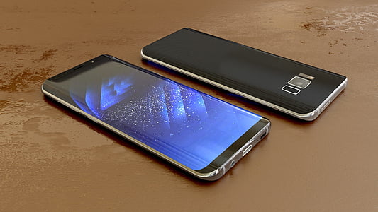 two black smartphones on brown surface thumbnail