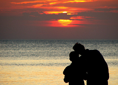 silhouette photo of two person on seashore thumbnail