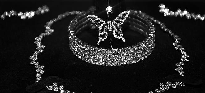 silver-colored butterfly pendant above silver-colored bracelet thumbnail