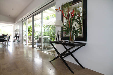 black wooden table and mirror beside clear glass sliding door thumbnail