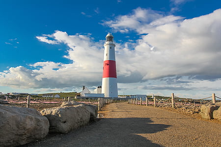 white and red lighthouse near body of water thumbnail