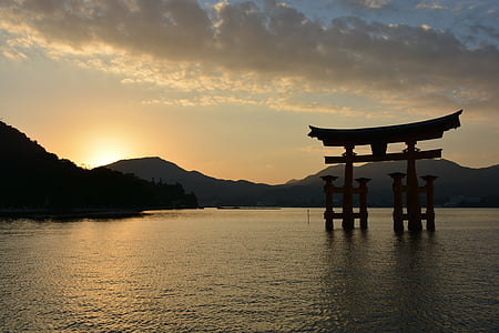 tori gate in body of water during golden hour thumbnail