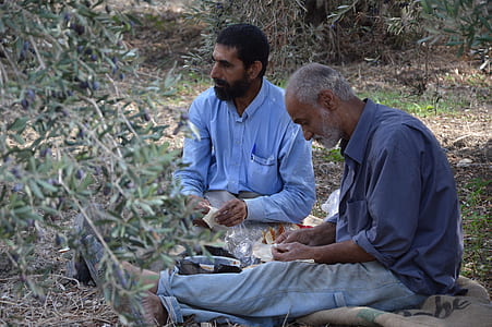 two men sitting on ground thumbnail