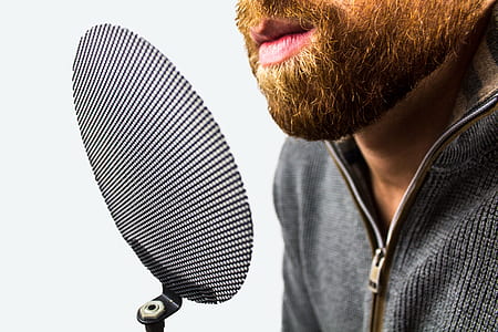 person near gray pop filter with white background thumbnail